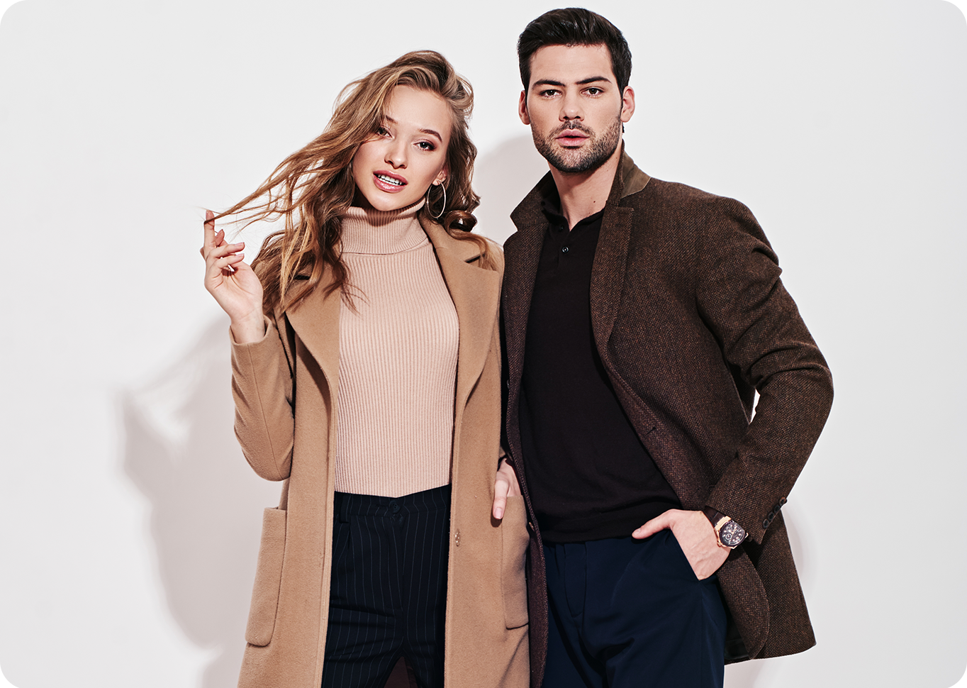 Fashion models wearing stylish coats and business casual apparel in a modern lifestyle fashion photoshoot.