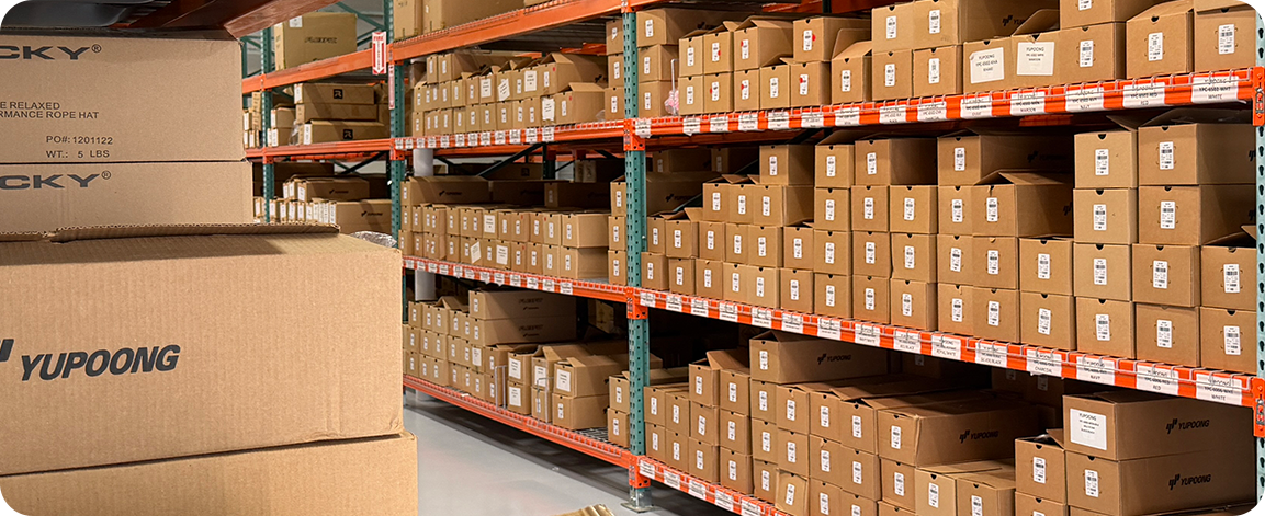 Warehouse shelves stocked with branded inventory boxes ready for storage, fulfillment, and distribution.