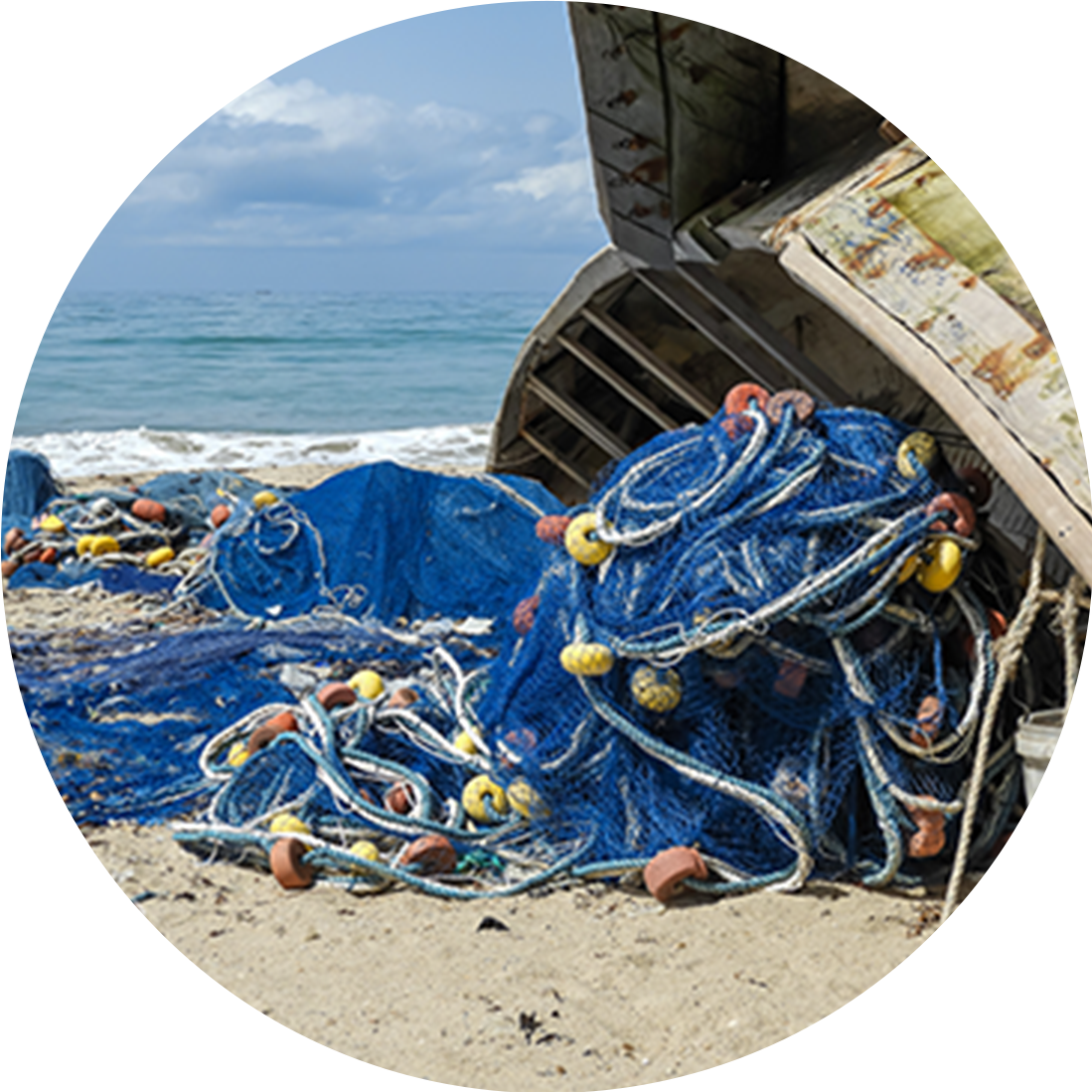 Discarded fishing nets and ropes on a beach, highlighting marine waste recycling and ocean conservation efforts.